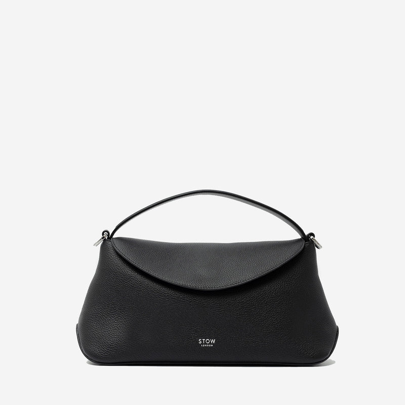 STOW London's East West in Black pebbled leather featuring silver stainless steel hardware on a light grey background