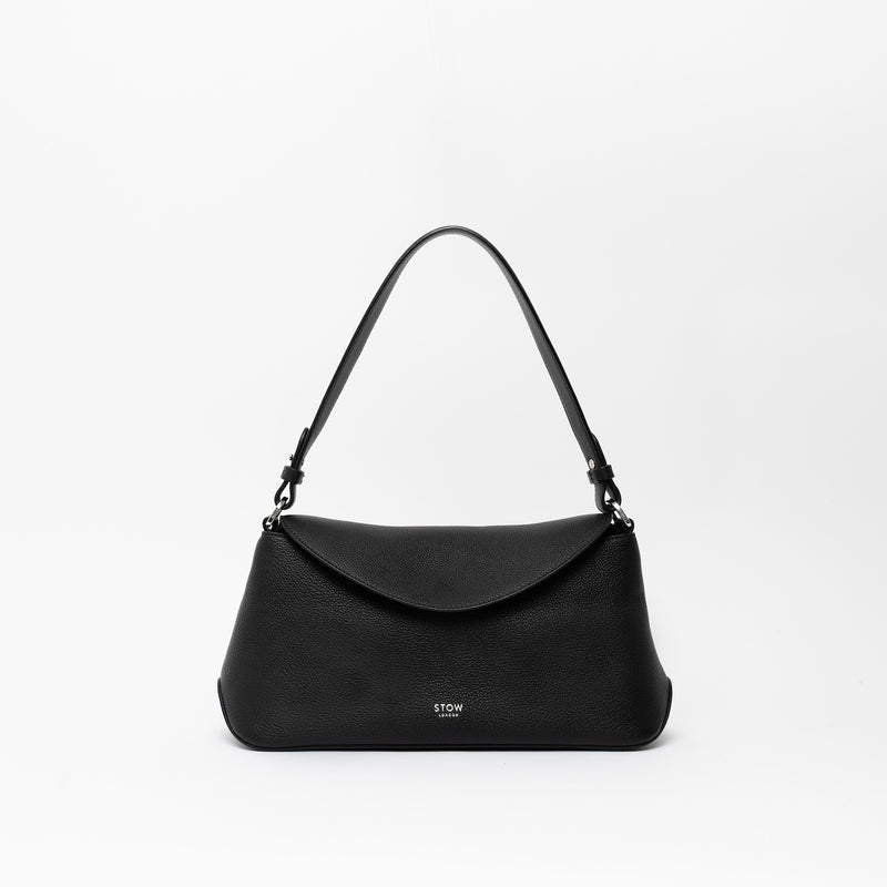 STOW London's East West and detachable shoulder strap in Black leather on a light grey background featuring silver hardware and details 