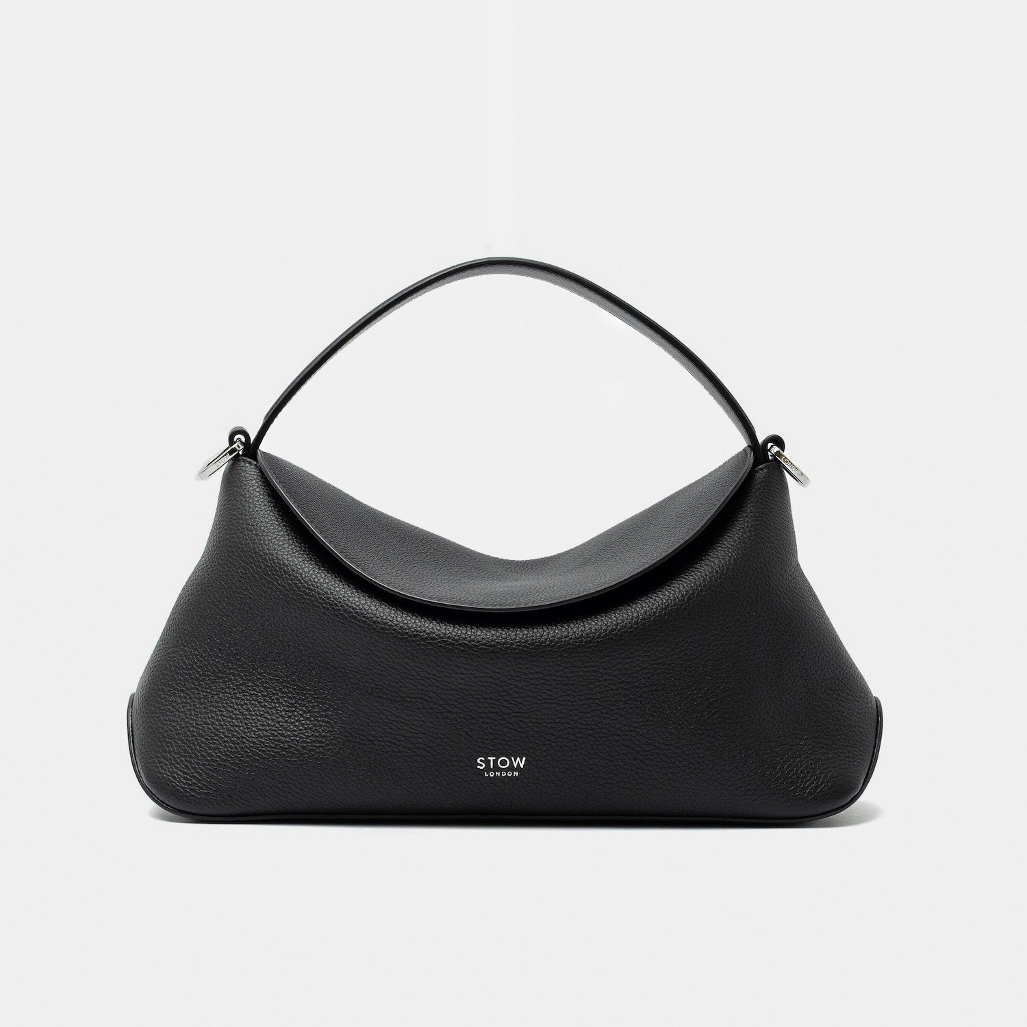 STOW London's East West in Black pebbled leather featuring silver stainless steel hardware on a light grey background