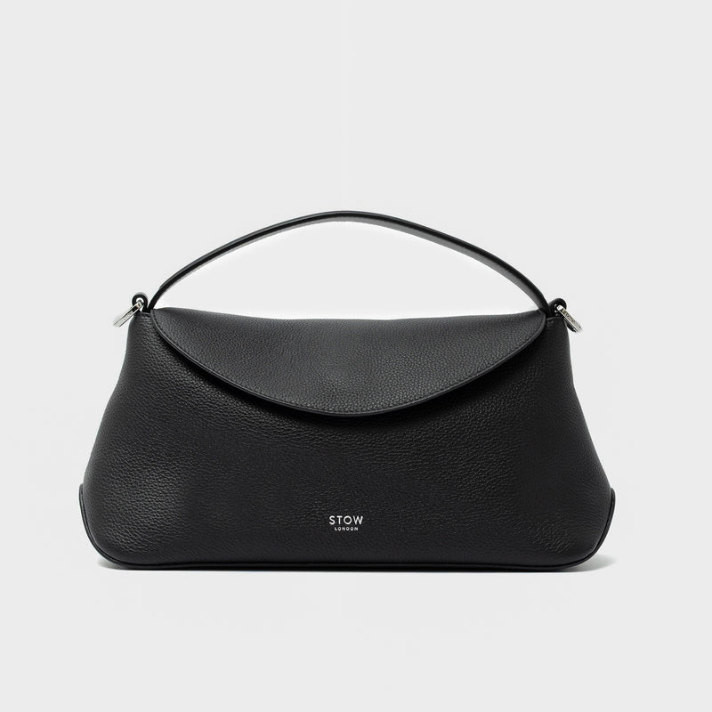 STOW London's East West in Black pebbled leather featuring silver stainless steel hardware on a light grey background