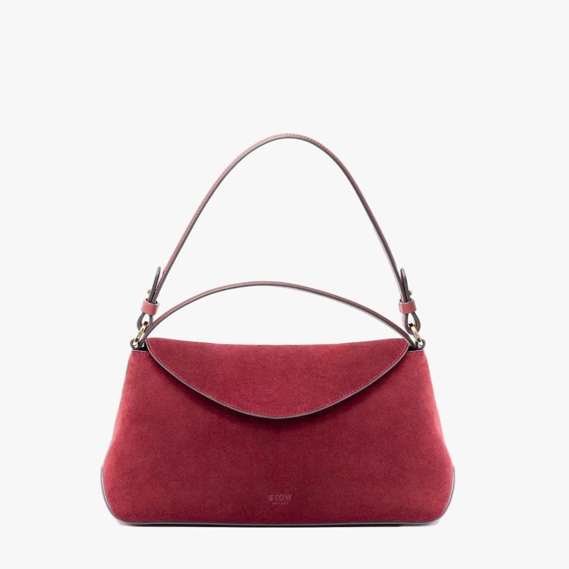 STOW London's East West in Burgundy suede leather on a light grey background featuring the detachable shoulder strap and top handle with gold hardware and details 