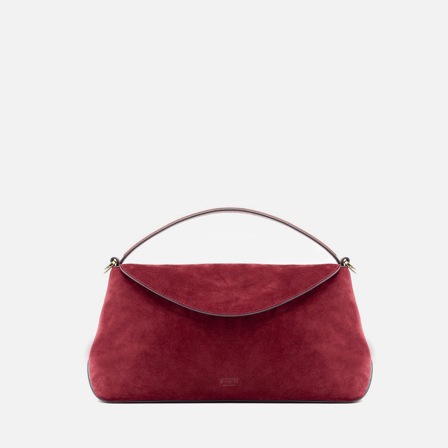 STOW London's East West in Burgundy suede leather featuring gold-coated stainless steel hardware on a light grey background