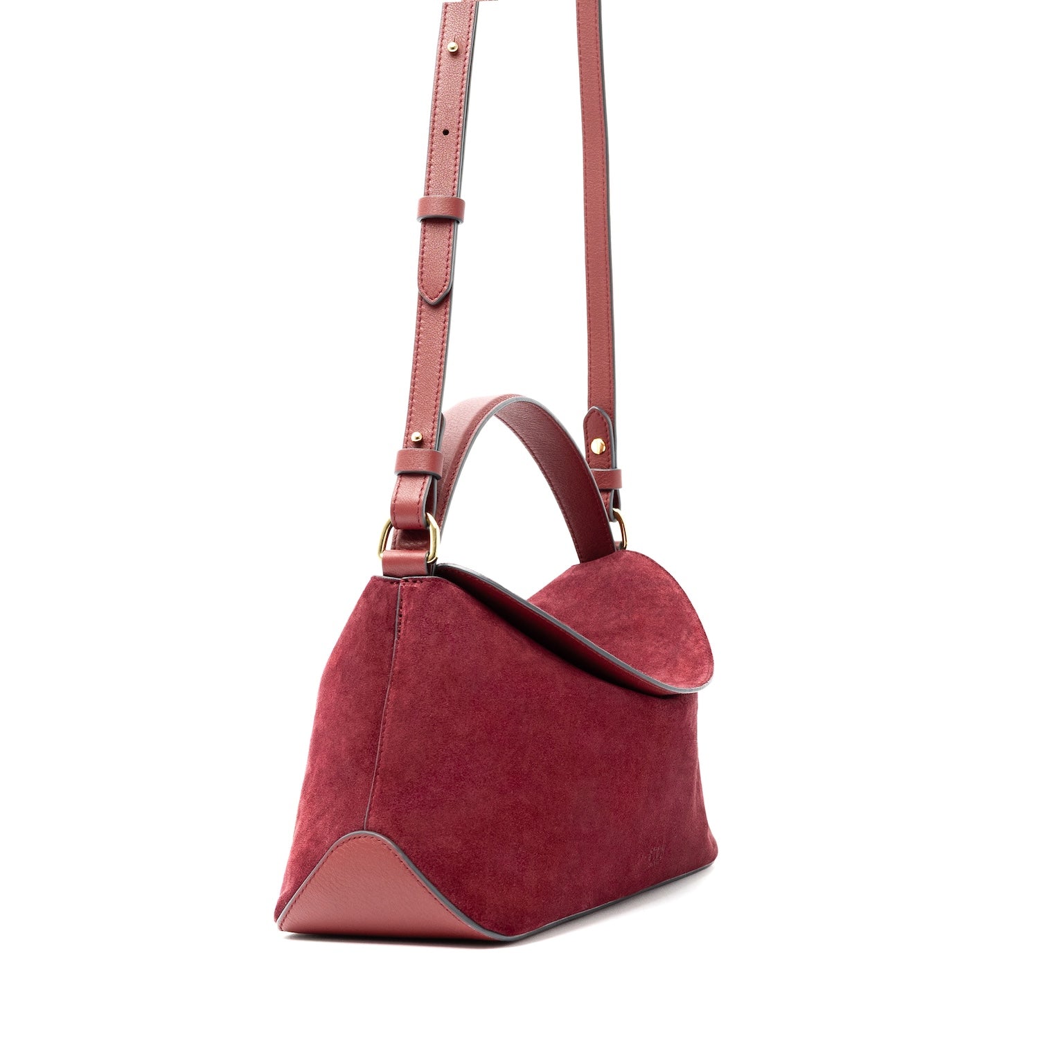 Side view of STOW London's East West bag and detachable, adjustable crossbody strap in Burgundy Suede leather featuring gold-coated stainless steel hardware on a white background
