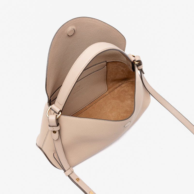 STOW London's East West in Camel pebbled leather with flap open showing the light beige suede interior and slip pocket featuring gold-coated stainless steel hardware on a light grey background