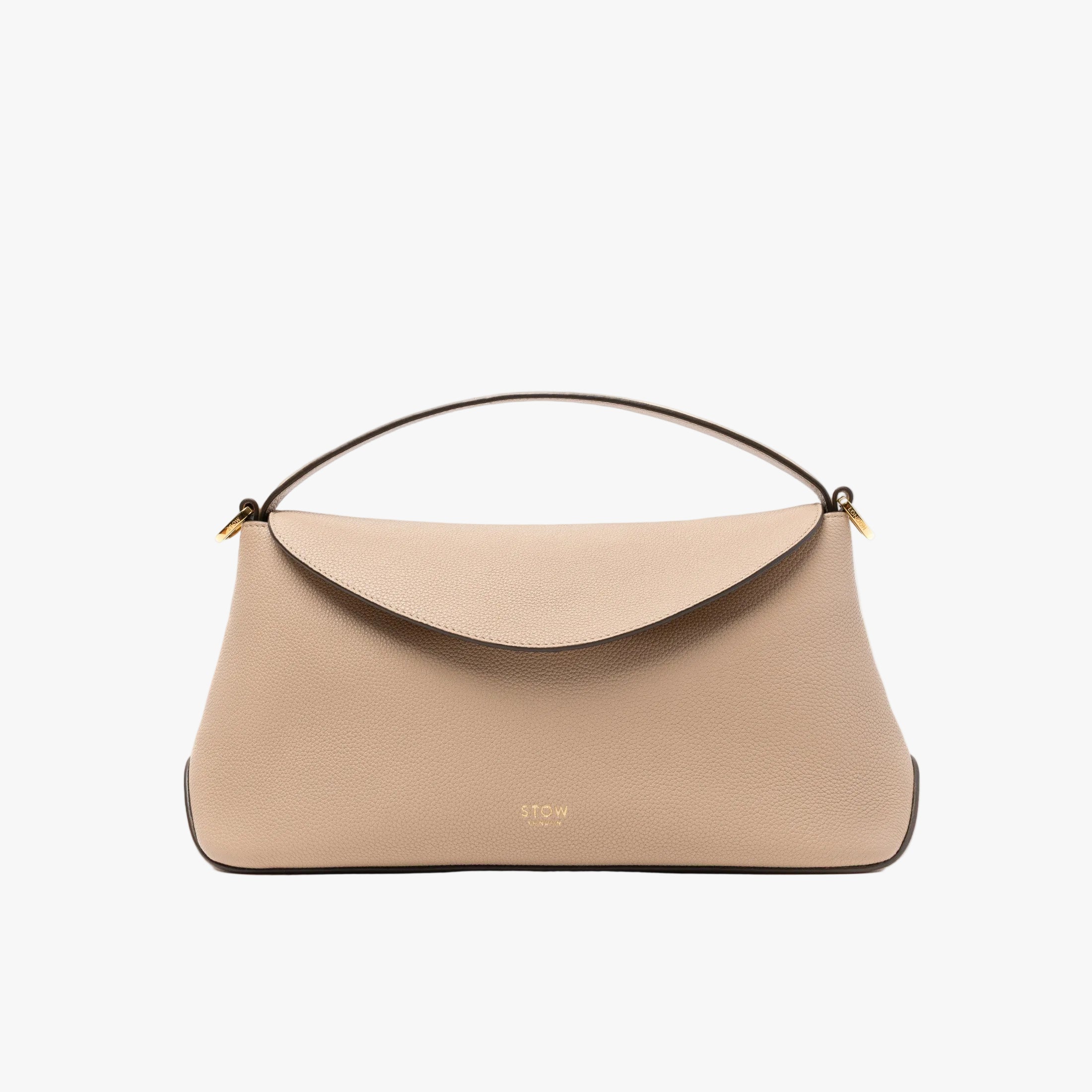 STOW London's East West in Camel pebbled leather featuring gold-coated stainless steel hardware on a light grey background