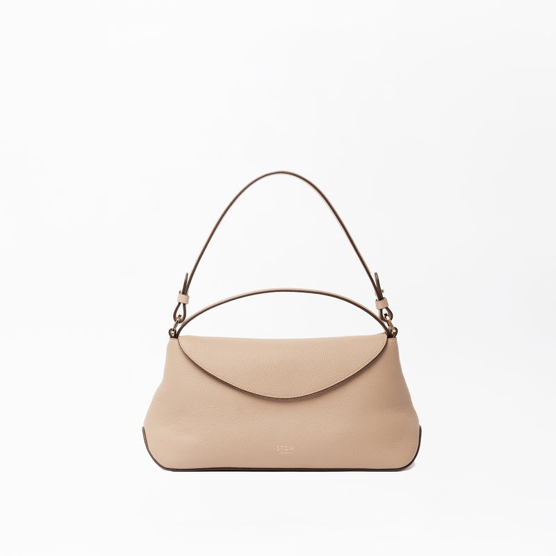STOW London's East West in Camel leather on a light grey background featuring the detachable shoulder strap and top handle with gold hardware and details 