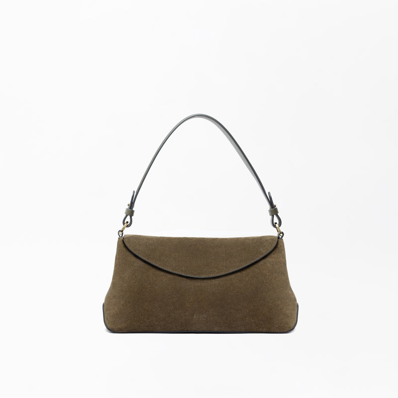 STOW London's East West in Dark Green suede leather on a light grey background featuring the detachable shoulder strap with gold hardware and details 