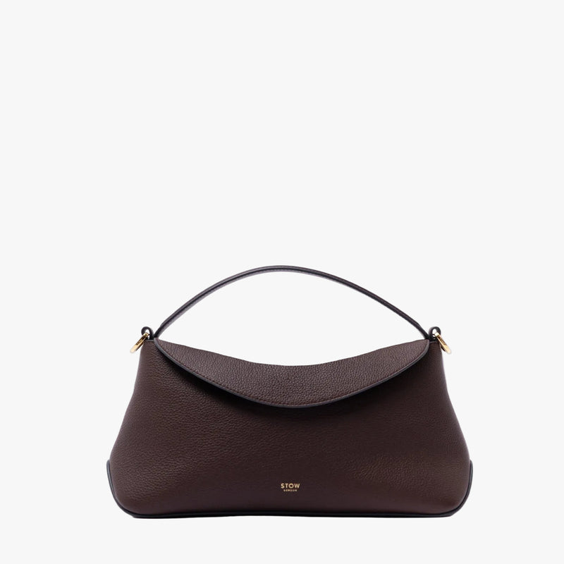 STOW London's East West in Espresso pebbled leather featuring gold-coated stainless steel on a light grey 