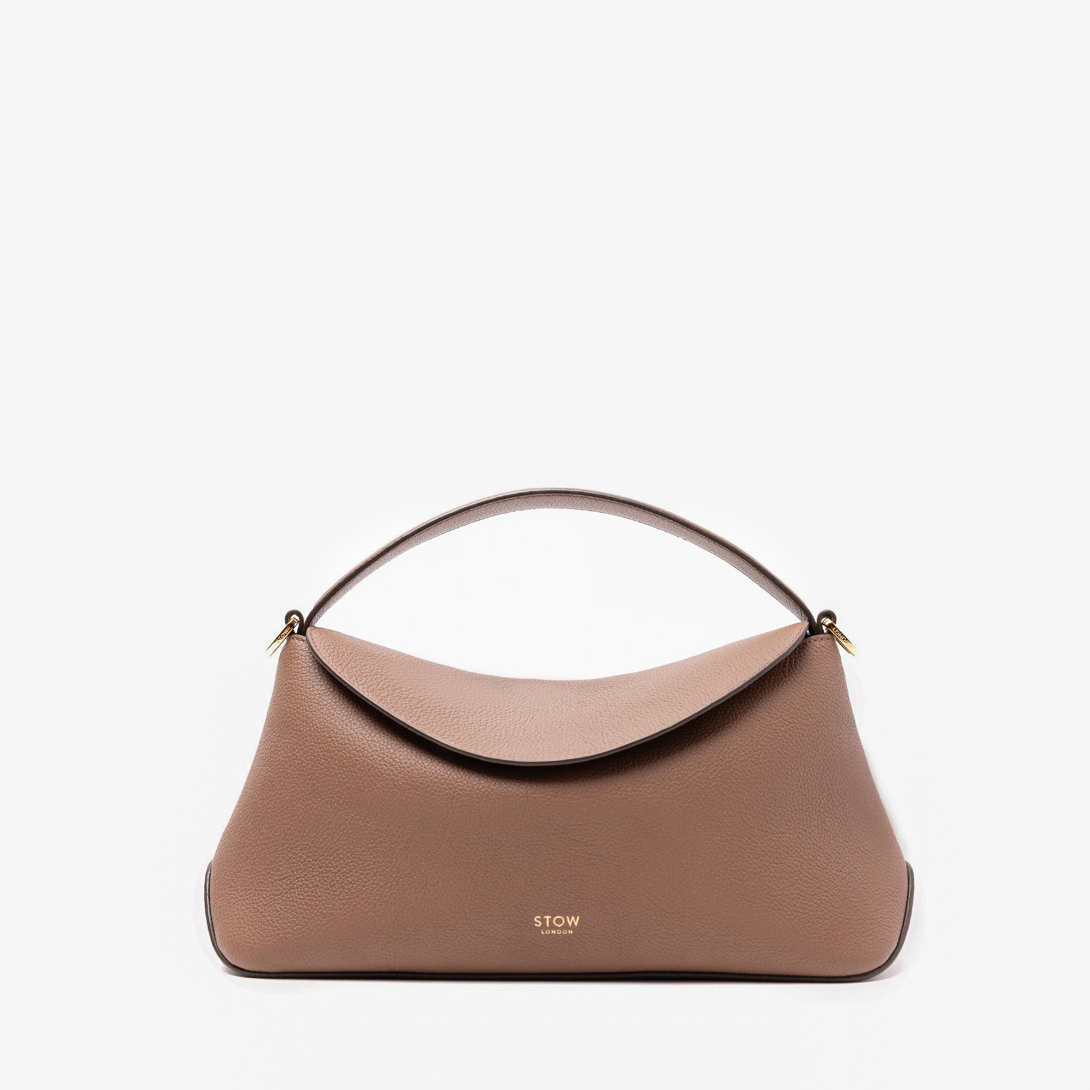STOW London's East West in Mocha pebbled leather featuring gold-coated stainless steel hardware on a light grey background