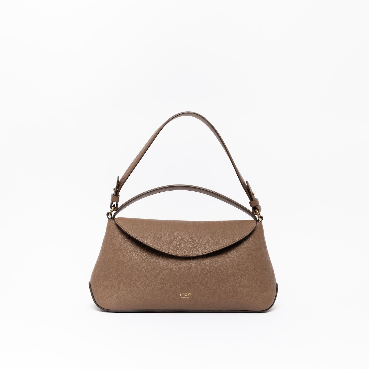 STOW London's East West, detachable shoulder strap and top handle in Mocha leather on a light grey background featuring gold hardware and details 