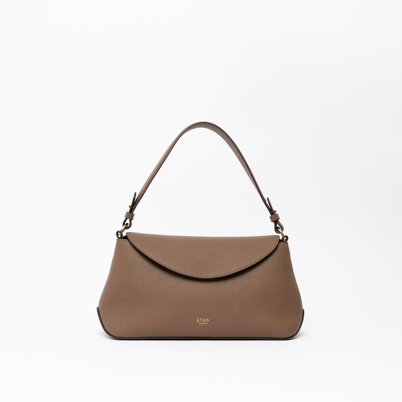 STOW London's East West and detachable shoulder strap in Mocha leather on a light grey background featuring gold hardware and details 