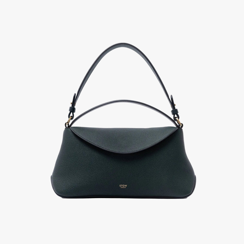 STOW London's East West in New Forest pebbled leather on a light grey background featuring the detachable shoulder strap and gold-coated stainless steel hardware
