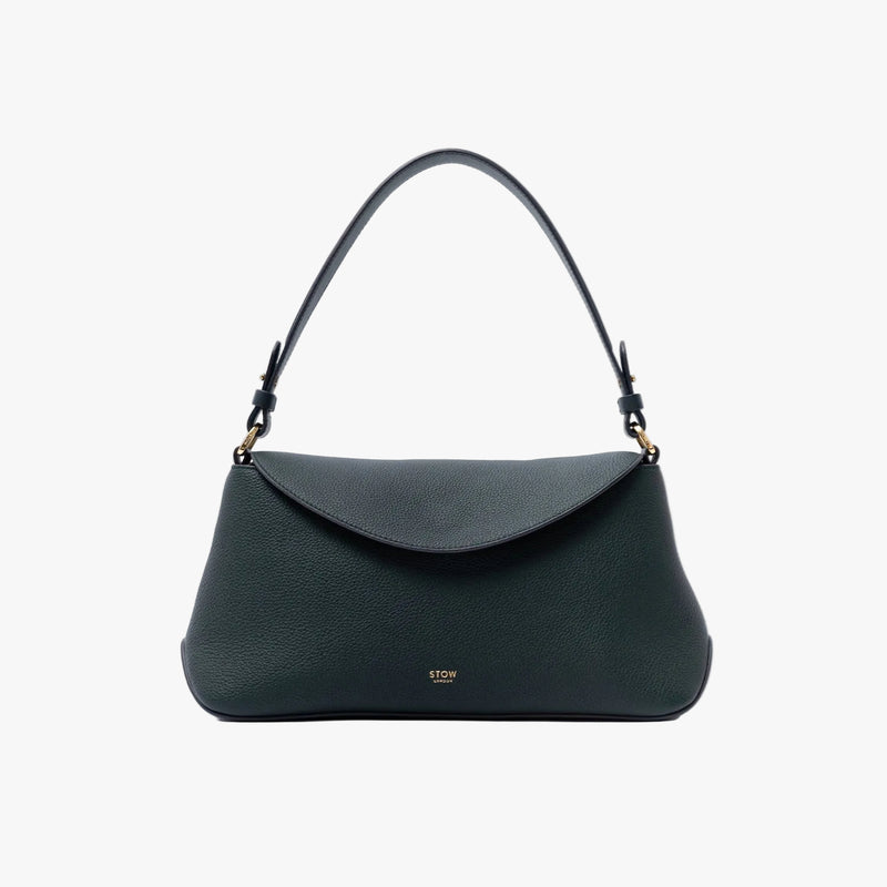 STOW London's East West in New Forest pebbled leather on a light grey background featuring the detachable shoulder strap and gold-coated stainless steel hardware