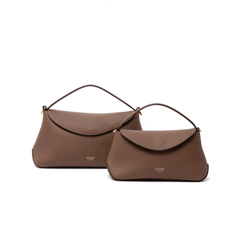 Size comparison of STOW London's Mini East West in Mocha leather and the bigger East West bag in Mocha on a white background featuring gold-coated stainless steel hardware 