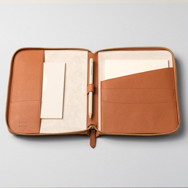 STOW London First Class Folio tech case in Earth Tan leather, shown open with papers inside
