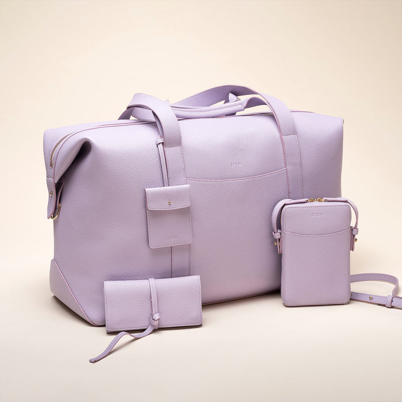 STOW Mini Jewellery Roll in Wild Lavender alongside rest of STOW Wild Lavender styles including the Leather Weekend Bag.