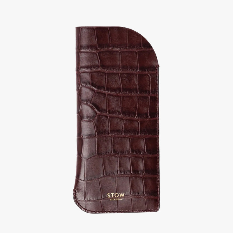 STOW London's Glasses Case in Burgundy Embossed Croc leather, featuring a gold logo on a light background