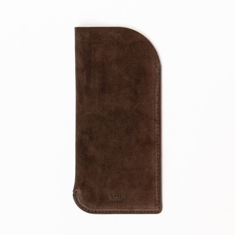 STOW London's Glasses Case in Chocolate suede leather on a light grey background featuring an embossed STOW London on front 