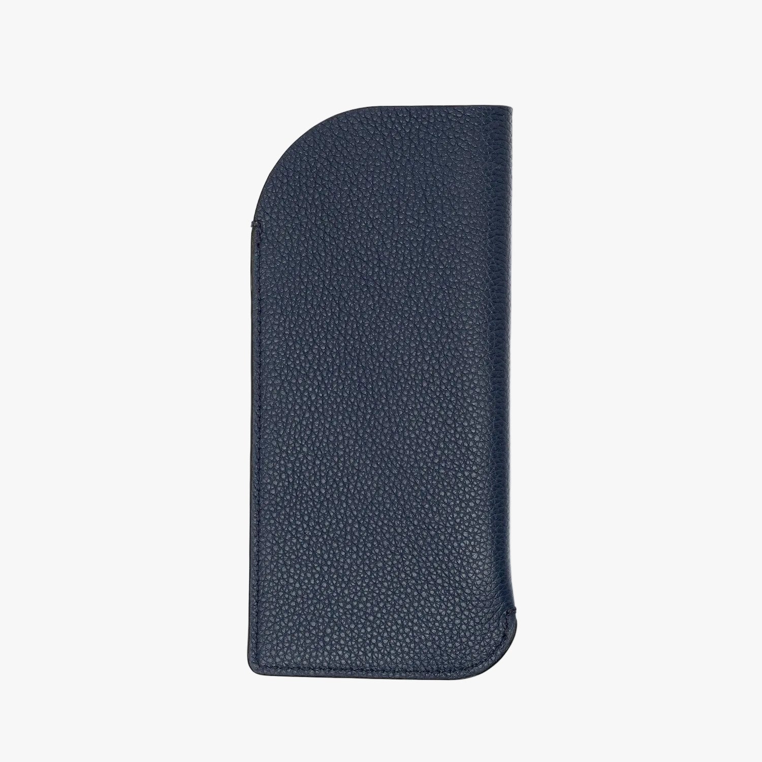 Back panel of STOW London's Glasses Case in Navy pebbled leather on a light grey background