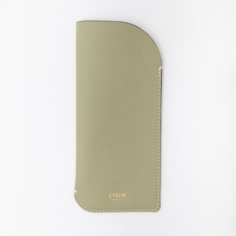 STOW London's Glasses Case in Pale Green pebbled leather, featuring a gold logo on a white background
