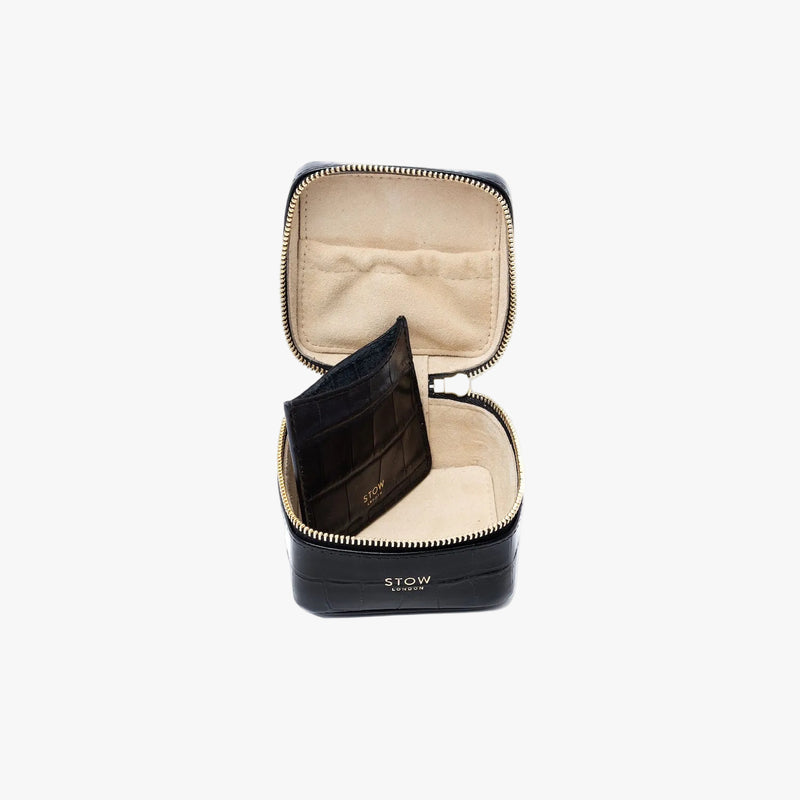STOW London's Hester Jewellery Case in Black Embossed Croc leather on a light grey background with zipper open showing the light Goat's suede interior, the elasticated pocket and leather slip pouch