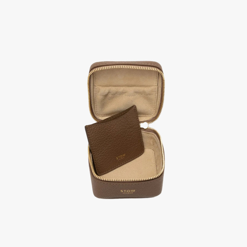 STOW London's Hester Jewellery Case in Mocha pebbled leather on a light grey background with zipper open showing the light Goat's suede interior, the elasticated pocket and leather slip pouch