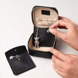 STOW Leather Hester Jewellery Case in Black colour, open showing two leather sleeves inside (included with case) and an assortment of jewellery.