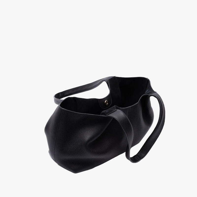 STOW London's Hobo Tote in Black pebbled leather on a light grey background with gold magnet open showing the black suede interior lining