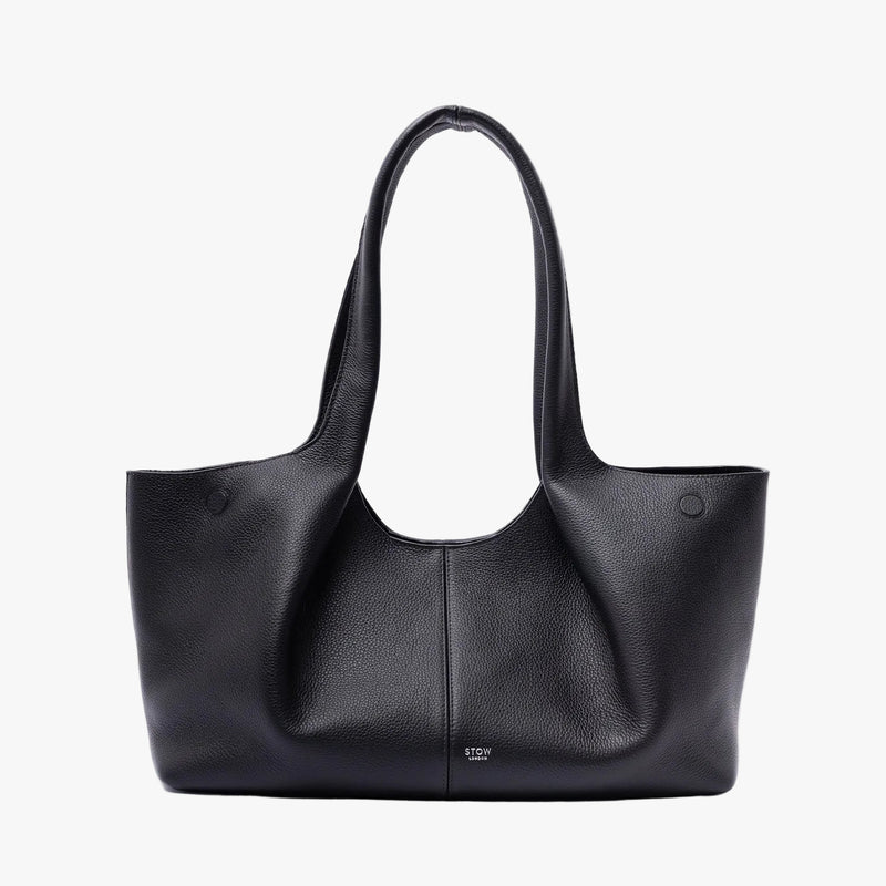 STOW London's Hobo Tote in Black pebbled leather on a light grey background featuring a pleated front panel and small silver embossed logo