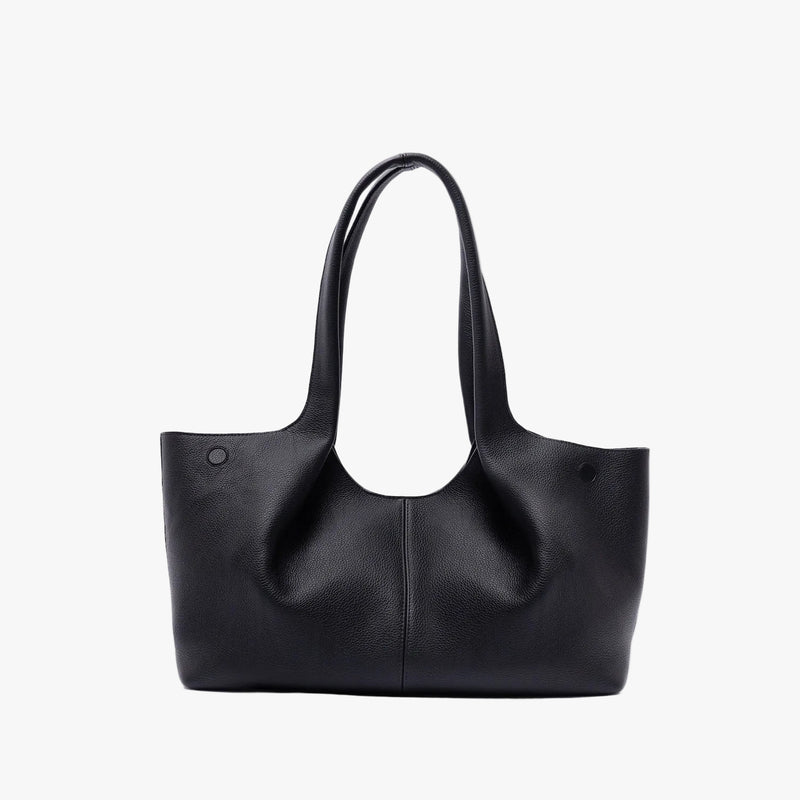 Back of STOW London's Hobo Tote in Black pebbled leather on a light grey background featuring a pleated back panel 