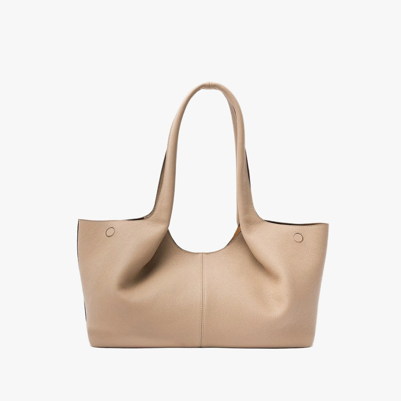 Back of STOW London's Hobo Tote in Camel pebbled leather on a light grey background featuring a pleated back panel 