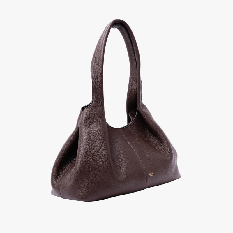STOW London's Hobo Tote in Espresso pebbled leather in its triangular hobo form on a light grey background featuring a pleated front panel and small gold embossed logo
