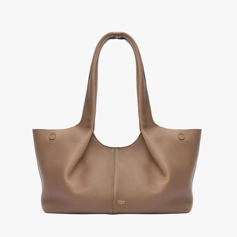 STOW London's Hobo Tote in Mocha pebbled leather on a light grey background featuring a pleated front panel and small gold embossed logo