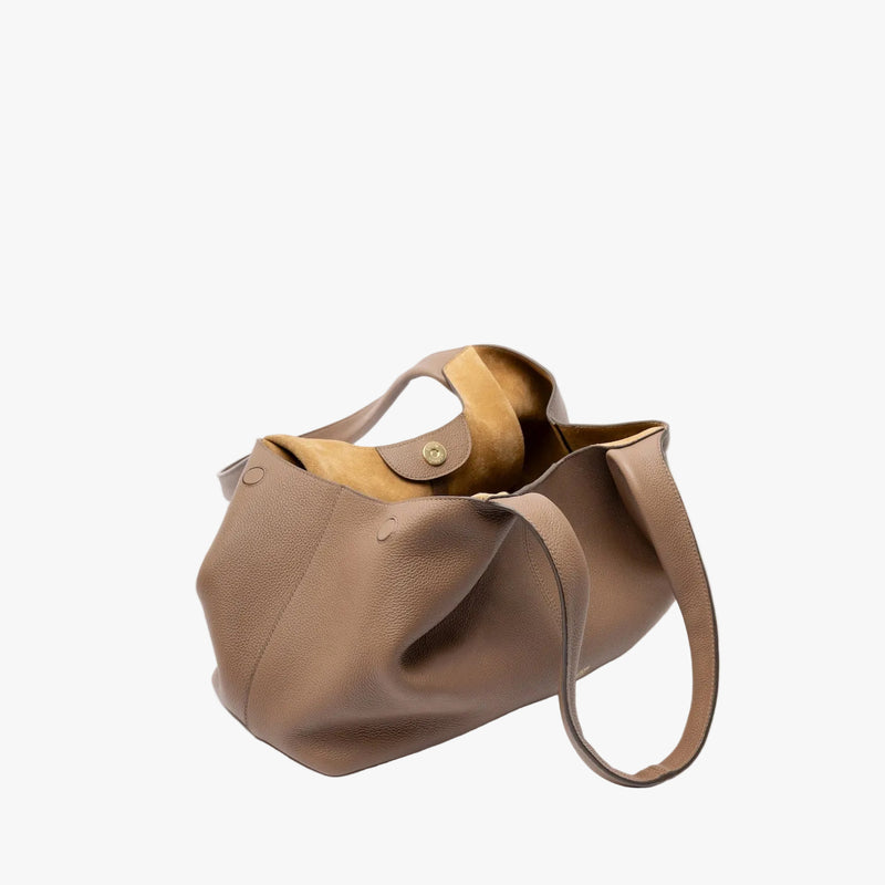 STOW London's Hobo Tote in Mocha pebbled leather with gold magnetic closure open showing the suede interior lining on a light grey background featuring the side magnets