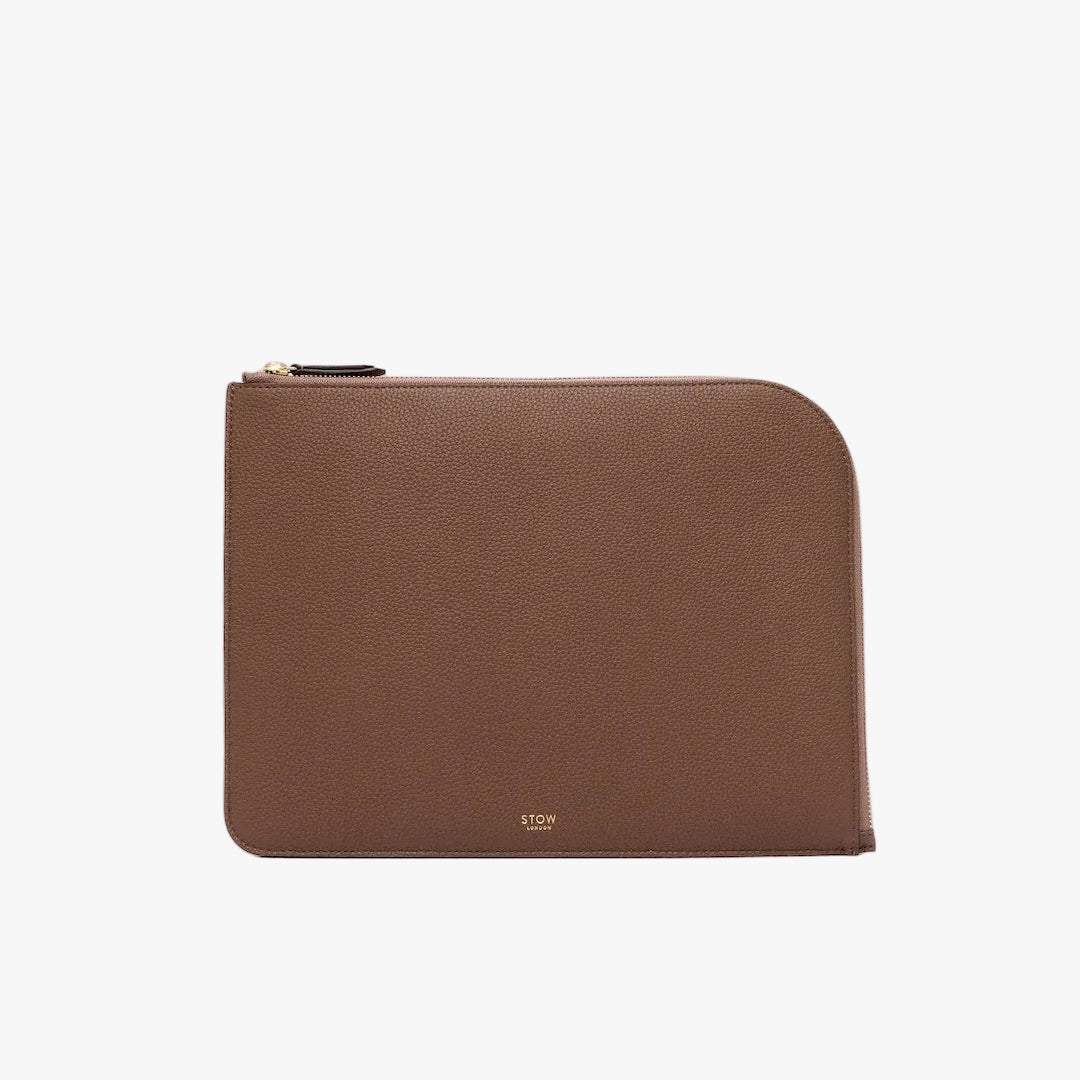 STOW London's Ipad Sleeve in Mocha pebbled leather on a light grey background featuring a YKK Natulon Zip and a fine gold embossed logo on the front bottom. 
