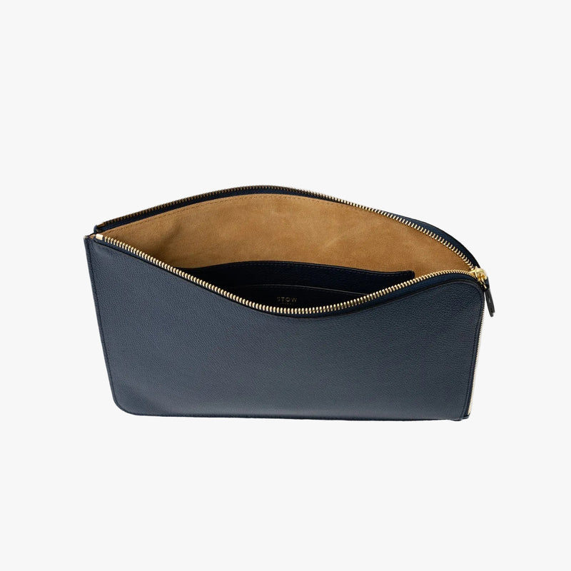 STOW London's Ipad Sleeve in Navy pebbled leather on a light grey background with zip open showing the velvety suede interior and leather slip pocket 
