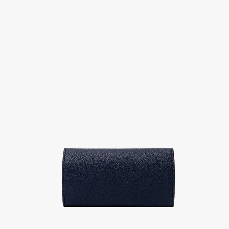 Back panel of STOW London's Jewellery Roll in Navy pebbled leather on a light grey background 