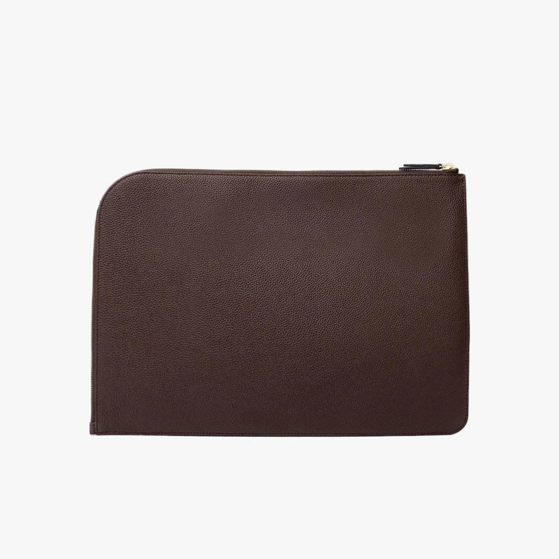Back Panel of STOW London's Laptop Sleeve in Espresso pebbled leather on a light grey background featuring a YKK Natulon Zip 