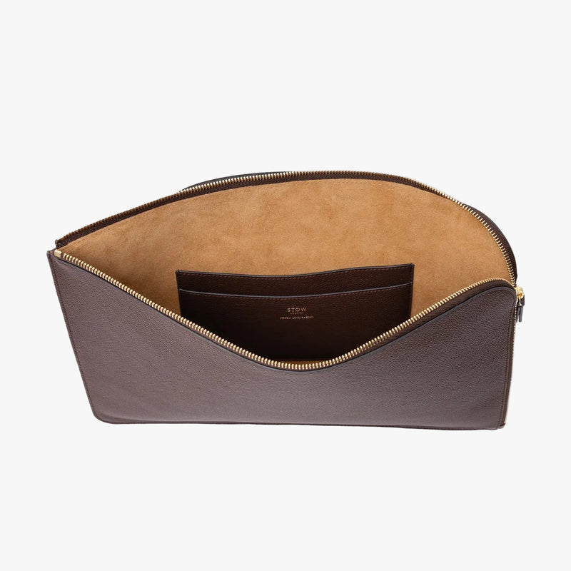STOW London's Laptop Sleeve in Espresso pebbled leather on a light grey background with zip open showing the velvety suede interior and leather slip pocket 