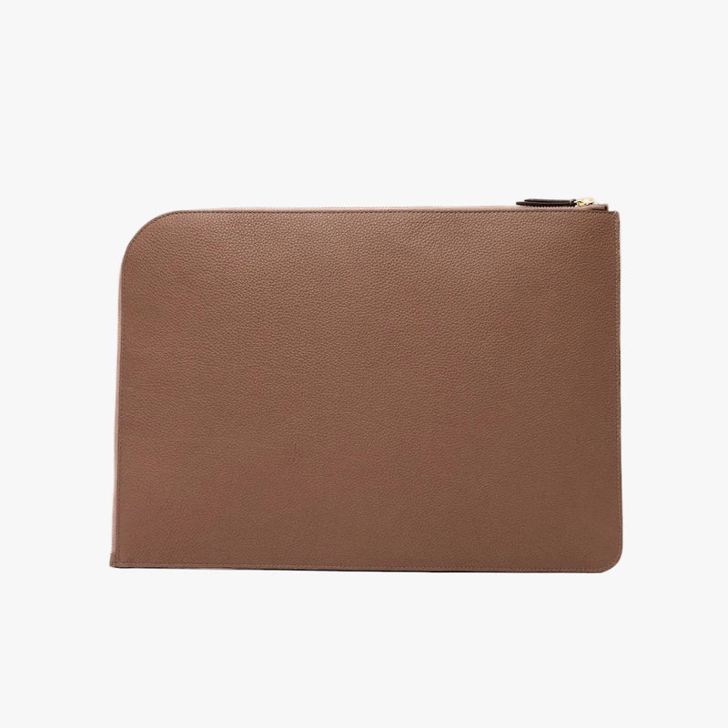 Back panel of STOW London's Laptop Sleeve in Mocha pebbled leather on a light grey background featuring a YKK Natulon Zip