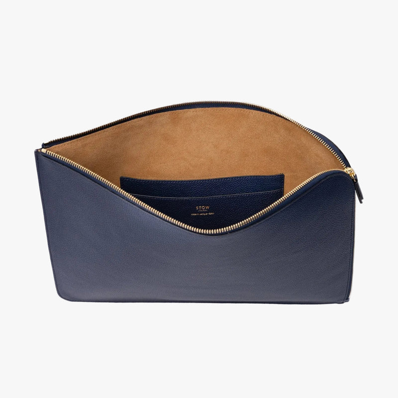 STOW London's Laptop Sleeve in Navy pebbled leather on a light grey background with zip open showing the velvety suede interior and leather slip pocket 
