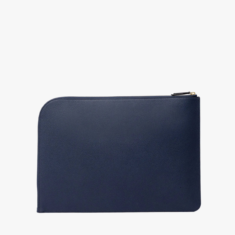 Back panel of STOW London's Leather Sleeve in Navy pebbled leather on a light grey background featuring a YKK Natulon Zip 