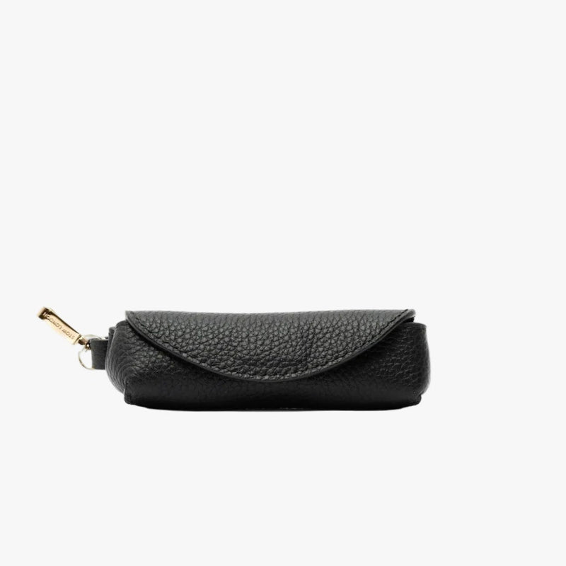 STOW London's Lipstick Case in Black pebbled leather featuring a gold-coated stainless steel clip on a light grey background
