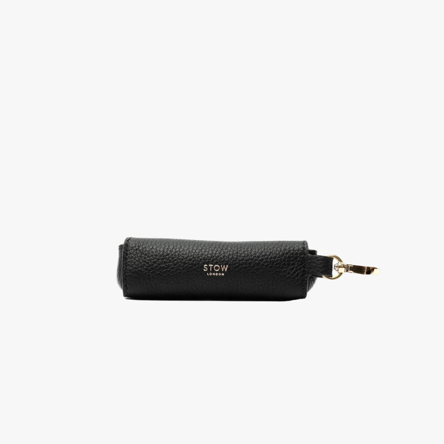 STOW London's Lipstick Case in Black pebbled leather featuring a gold-coated stainless steel clip and embossed logo on a light grey background