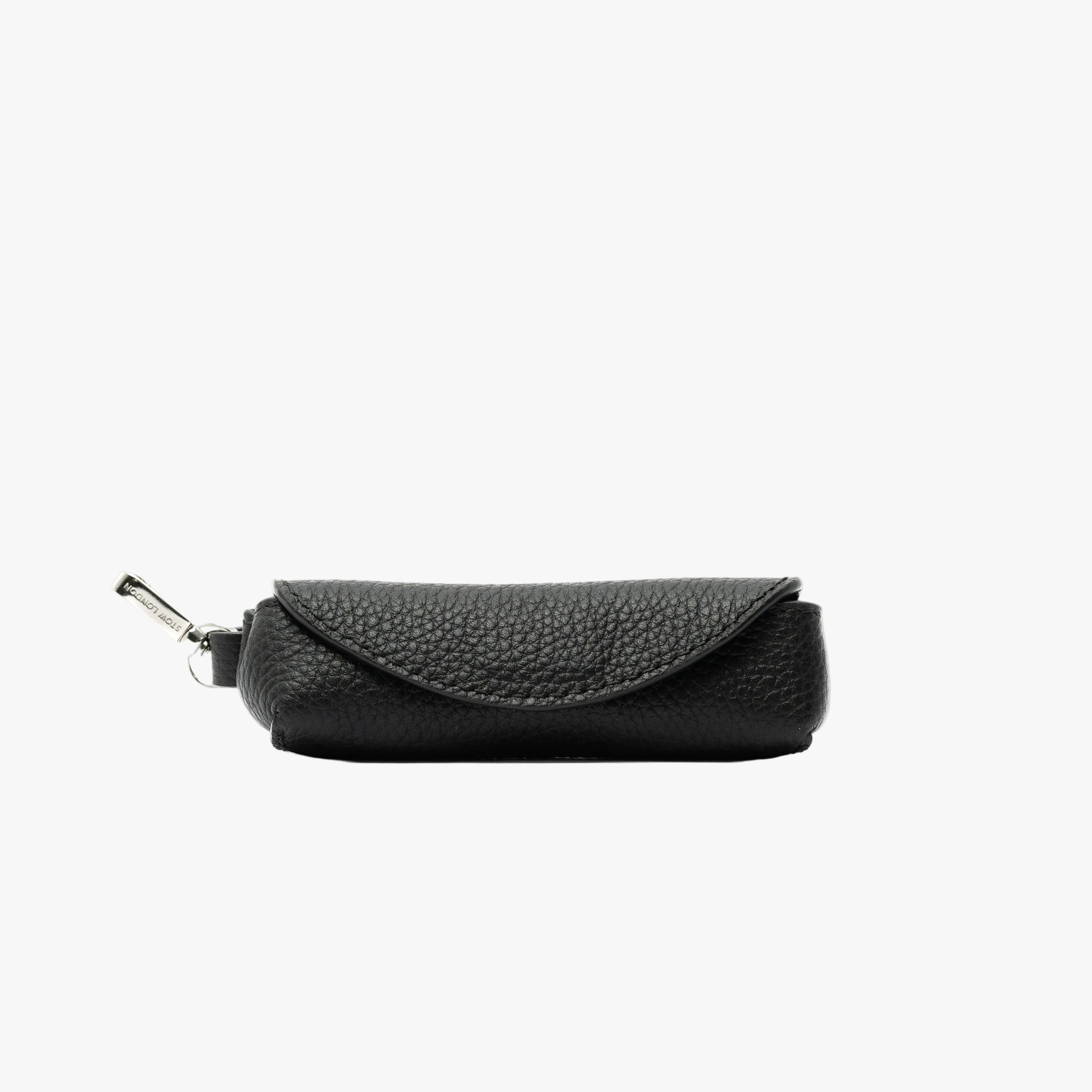 STOW London's Lipstick Case in Black pebbled leather featuring a silver stainless steel clip on a light grey background