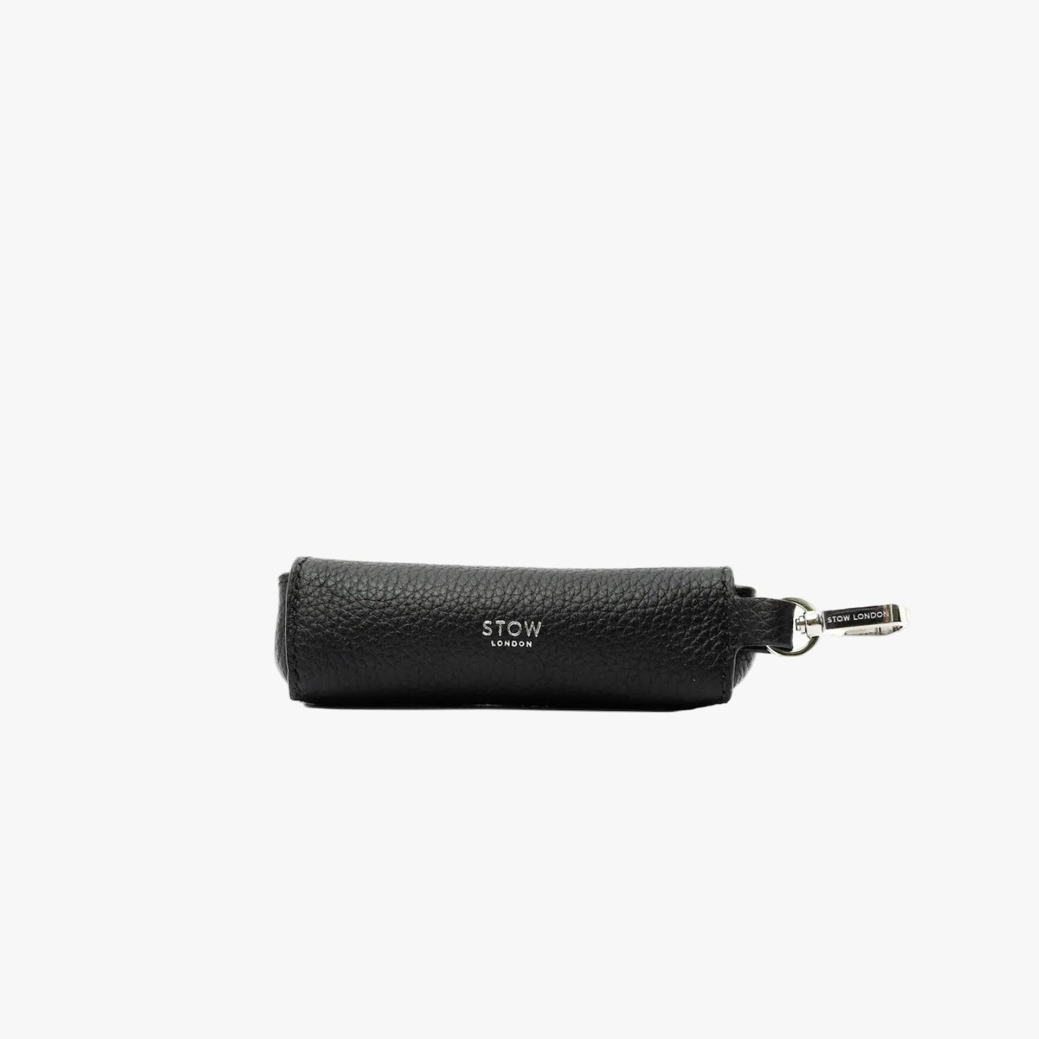 STOW London's Lipstick Case in Black pebbled leather featuring a silver stainless steel clip and embossed logo on a light grey background