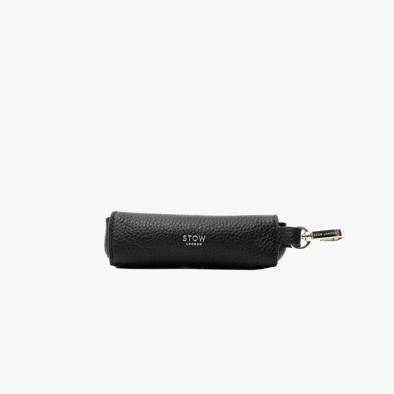 STOW London's Lipstick Case in Black pebbled leather featuring a silver stainless steel clip and embossed logo on a light grey background