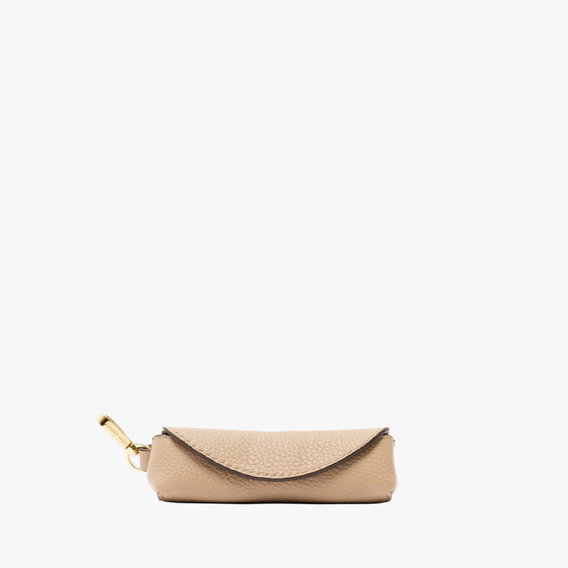 STOW London's Lipstick Case in Camel pebbled leather featuring a gold-coated stainless steel clip on a light grey background