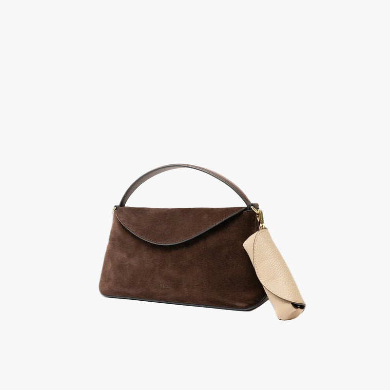 STOW London's Lipstick Case in Camel pebbled leather attached to the Mini East West in Chocolate suede leather on a light grey background featuring gold-coated stainless steel hardware