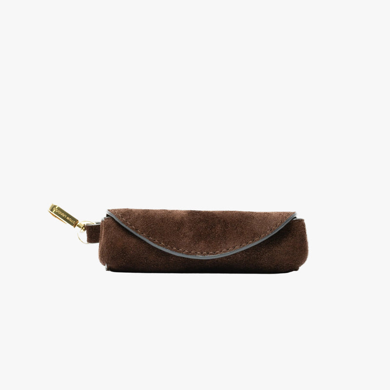 STOW London's Lipstick Case in Chocolate suede leather on a light grey background featuring a gold-coated stainless steel clip